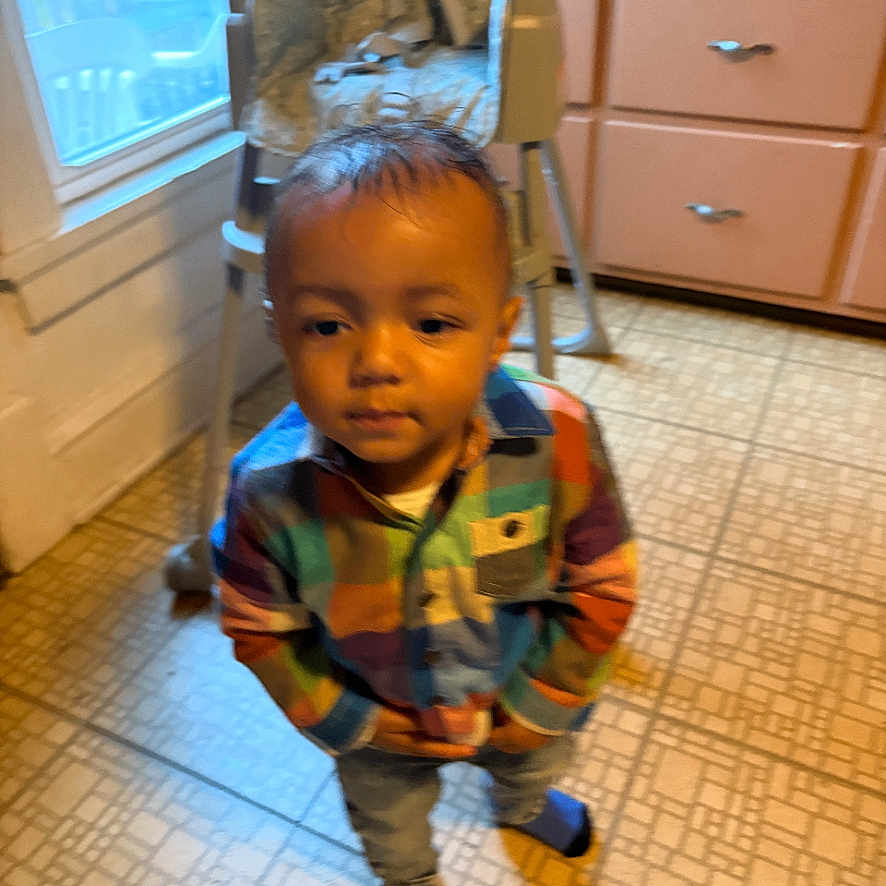 Chozyn joined the competition — help win amazing prizes! child, toddler, boy, portrait, standing, indoors, kitchen, plaid_shirt, colorful_clothing, pants, socks, short_hair, serious_expression, face, hands_in_pockets, floor, chair, window, dresser, home