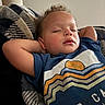 Rhyli Redmond is registered to the contest to win money with this photo: toddler, sleeping, child, curly_hair, blue_shirt, graphic_tee, blanket, cozy, relaxed, indoors, portrait, peaceful, rest, young_child, face, person, casual, comfort, nap, soft_light