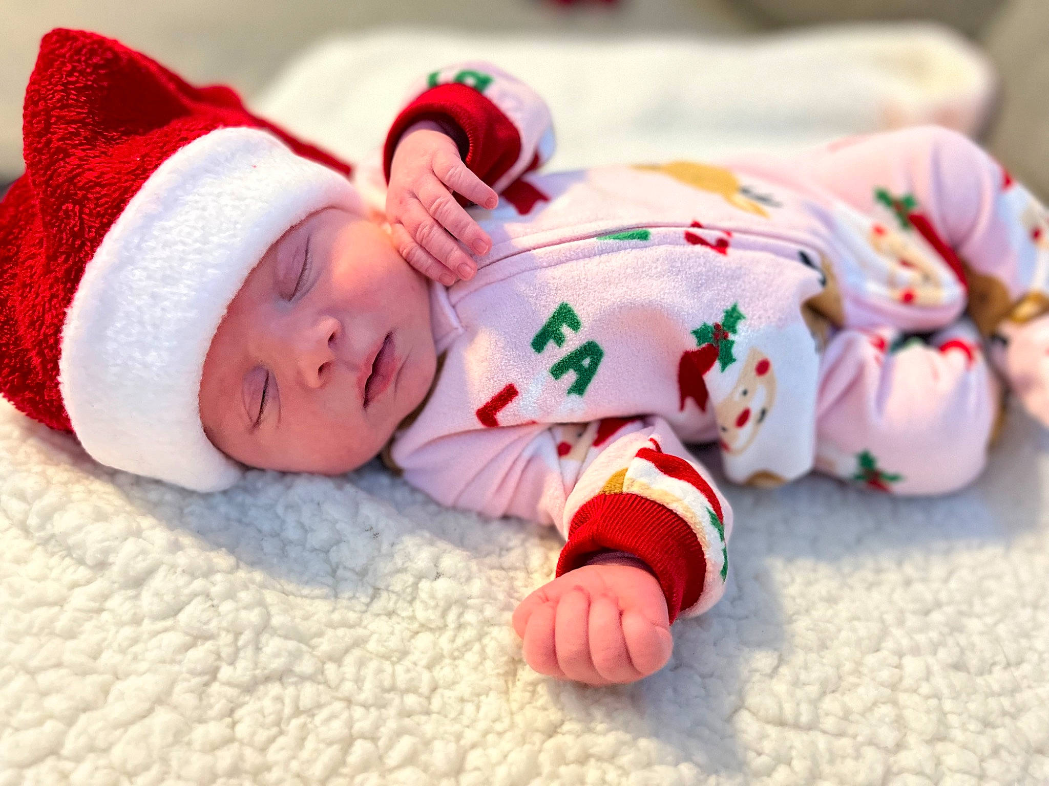 Brinley is registered to the contest to win money with this photo: baby, baby_sleeping, baby_toddler_clothing, child, christmas, comfort, event, eye, face, hand, happy, hat, head, headgear, headwear, human_body, leg, linens, person, skin