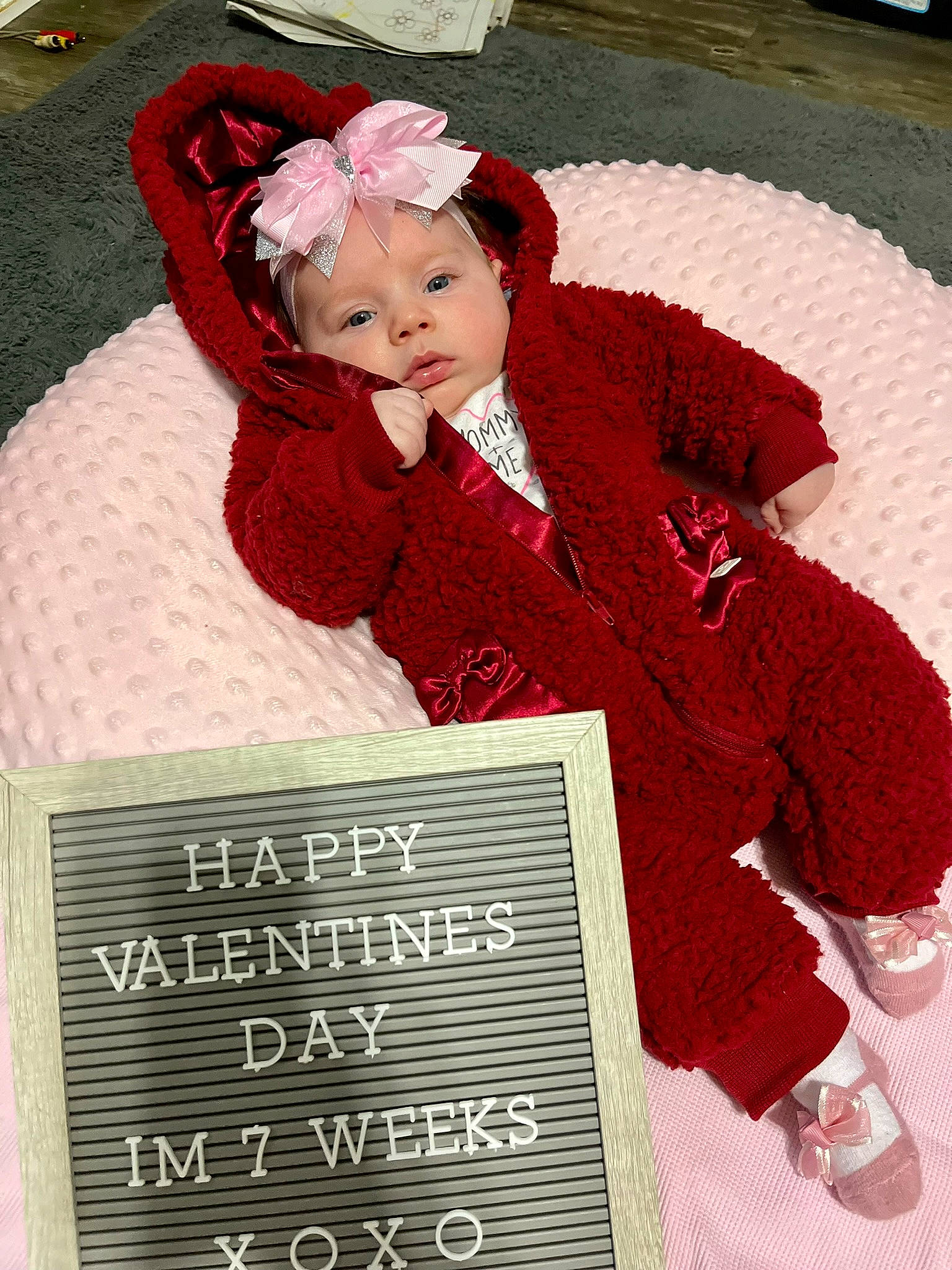 Brinley joined the competition — help win amazing prizes! baby, baby_toddler_clothing, carmine, child, costume, face, font, happy, hat, headgear, headwear, magenta, pattern, person, photo_caption, sitting, smile, toddler, vintage_clothing, winter