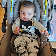 Ansh joined the competition — help win amazing prizes! baby, car_seat, batman, infant, smiling, child, clothing, indoor, seat, happy, person, cute, foot, hand, head, fabric, toy, playful, young, casual