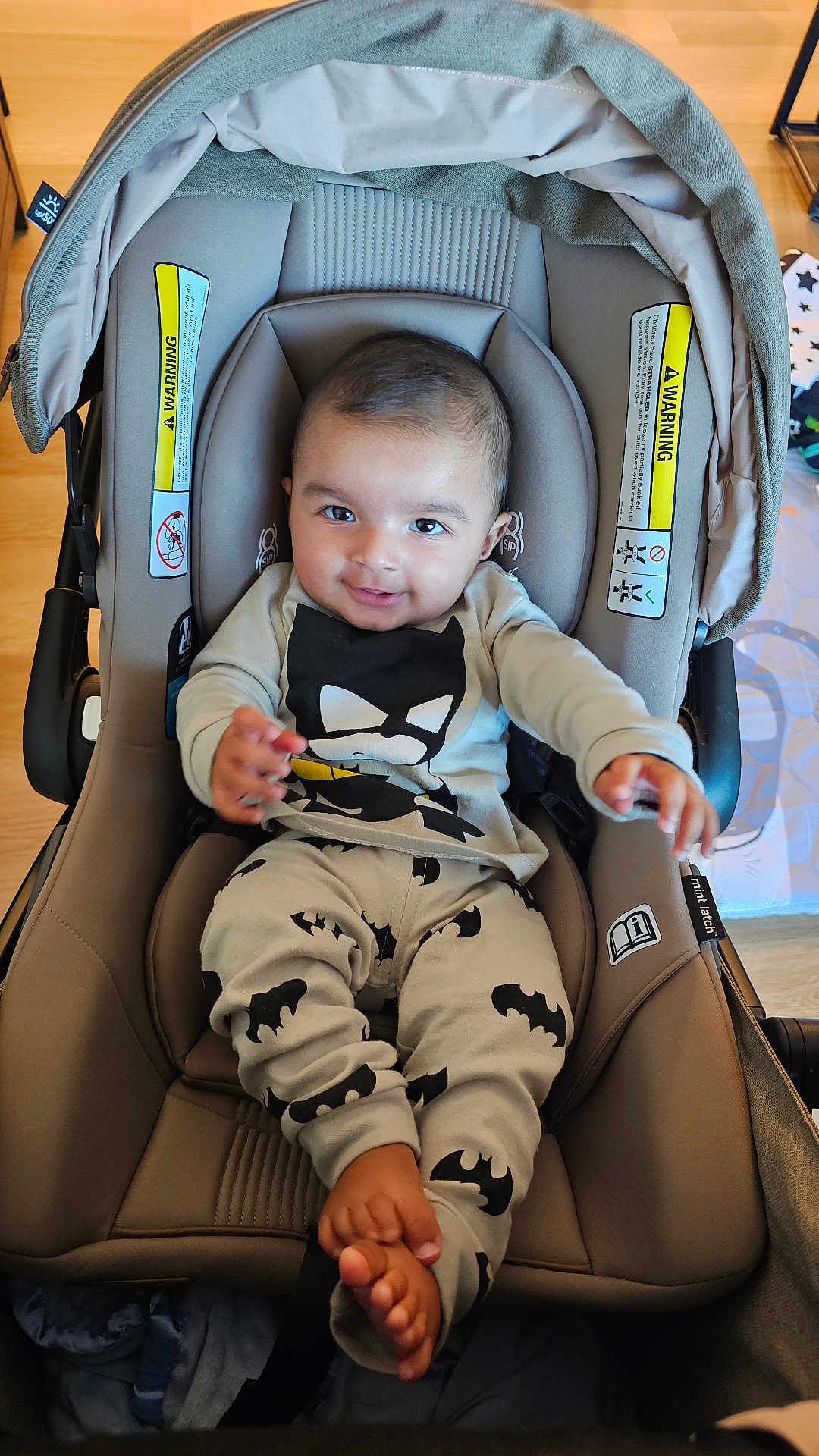 Ansh joined the competition — help win amazing prizes! baby, car_seat, batman, infant, smiling, child, clothing, indoor, seat, happy, person, cute, foot, hand, head, fabric, toy, playful, young, casual