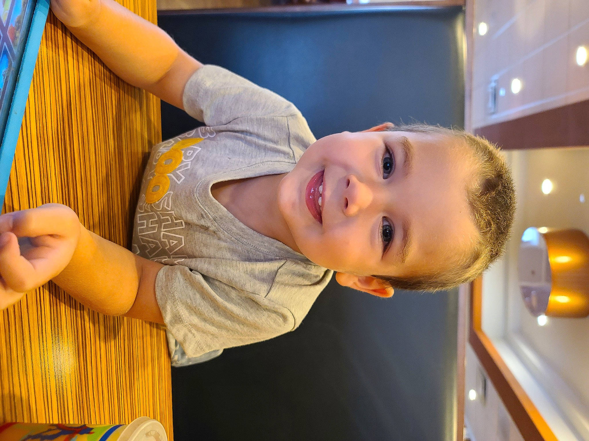 Tripp is registered to the contest to win money with this photo: arm, baby, child, elbow, fun, happy, joy, laugh, leisure, nose, person, room, smile, t_shirt, toddler, vacation, wood