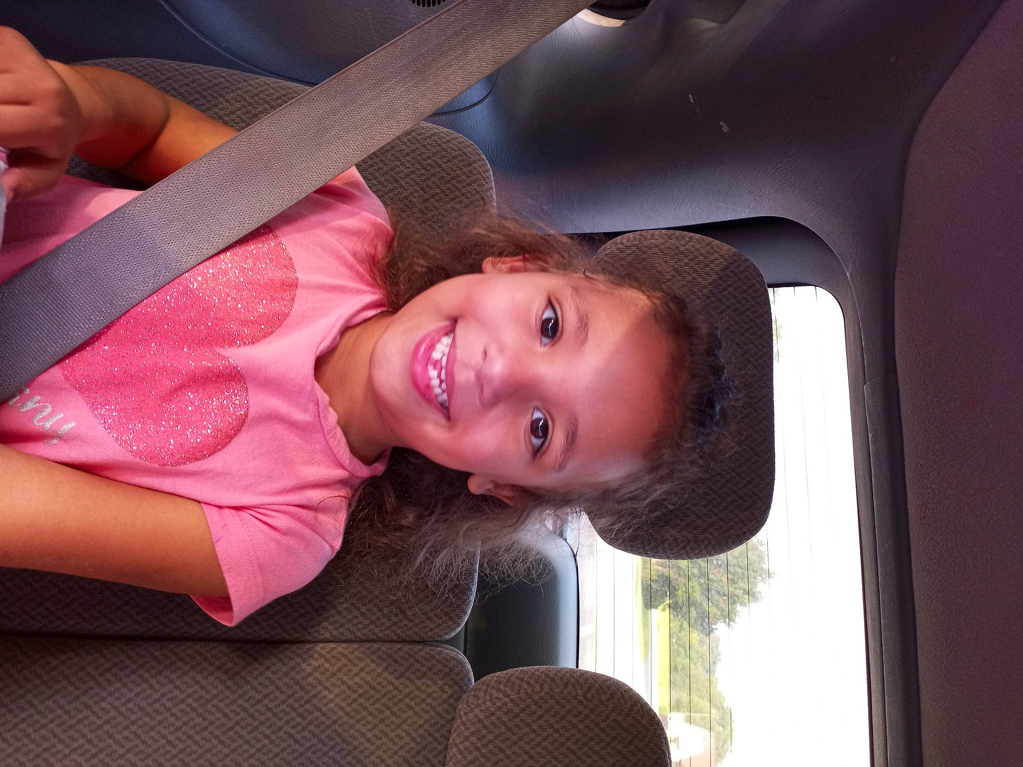 Haiden is registered to the contest to win money with this photo: auto_part, automotive_exterior, blond, child, chin, eyebrow, eyelash, flash_photography, fun, happy, joy, leisure, lip, mouth, nose, person, skin, smile, tints_and_shades, tree