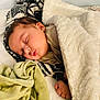 Adrian is registered to the contest to win money with this photo: baby, sleeping, blanket, cozy, soft, pillow, child, face, closed_eyes, hand, indoors, cute, rest, comfort, warm, bed, nap, peaceful, infant, puckered_lips