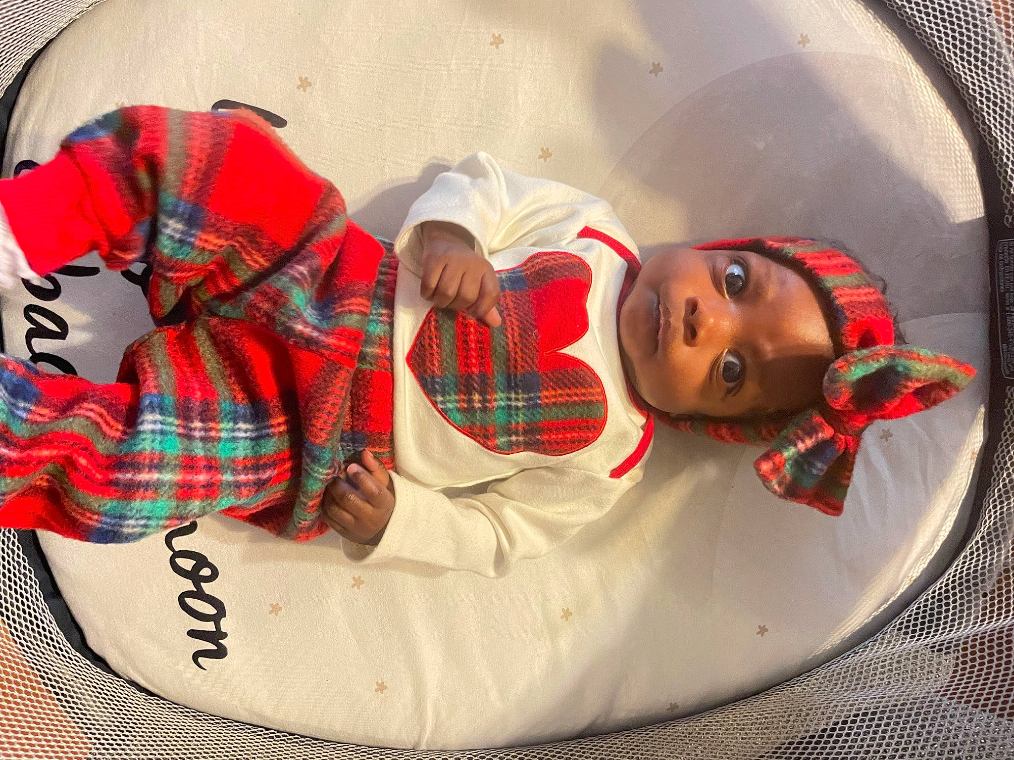 Faith is registered to the contest to win money with this photo: baby, carmine, child, circle, comfort, design, doll, eyewear, fashion_accessory, headgear, human_leg, linens, pattern, person, personal_protective_equipment, plaid, sunglasses, tartan, textile, thigh