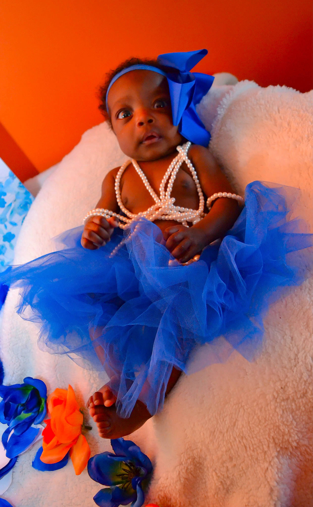 Faith is registered to the contest to win money with this photo: abdomen, azure, baby, baby_toddler_clothing, blue, child, electric_blue, event, finger, fun, happy, human, nail, orange, organ, peach, person, petal, textile, toddler