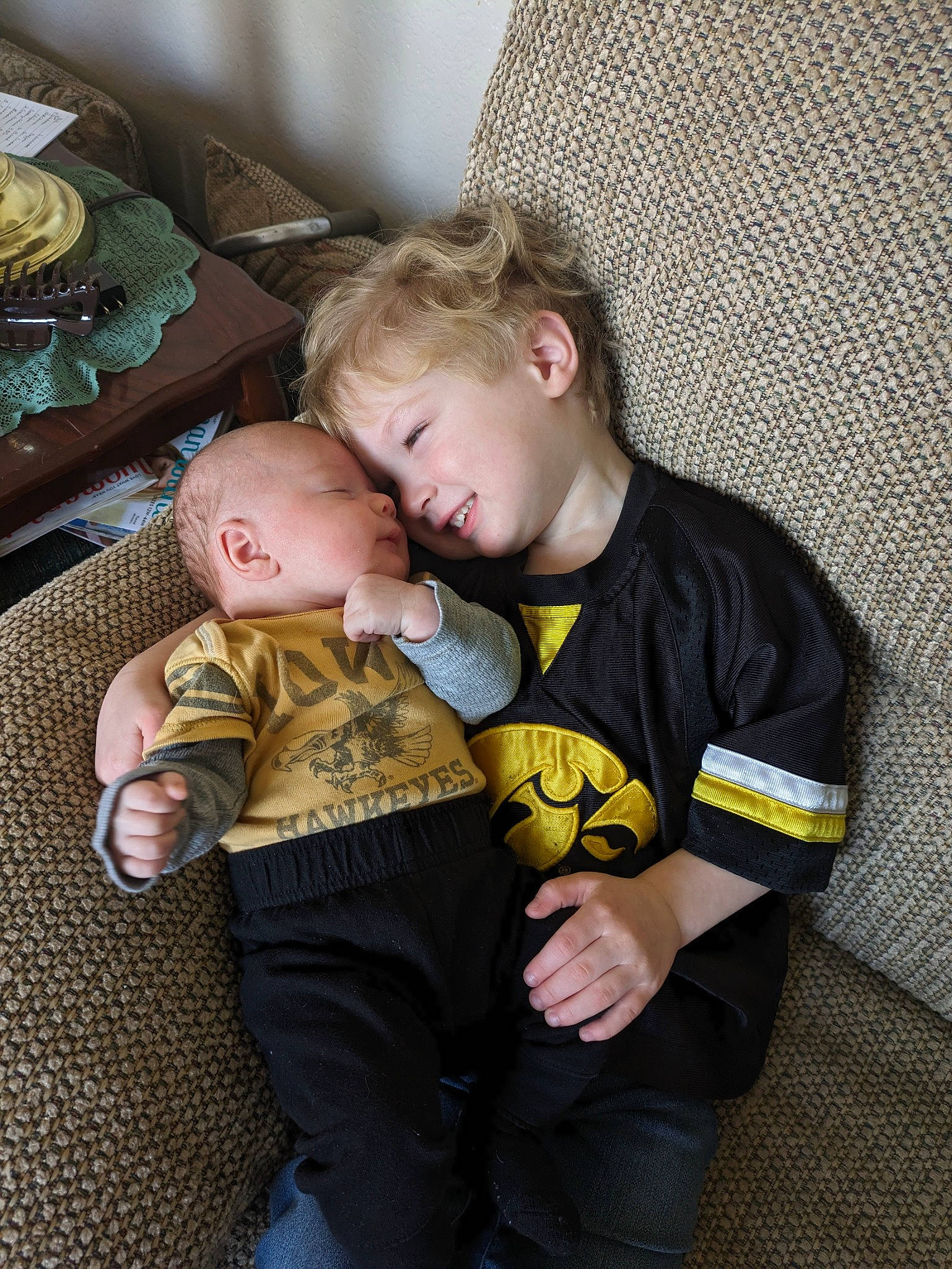 Ragnar And Levi is registered to the contest to win money with this photo: baby, baby_products, baby_toddler_clothing, child, comfort, couch, flooring, fun, lap, person, room, sitting, toddler, wood