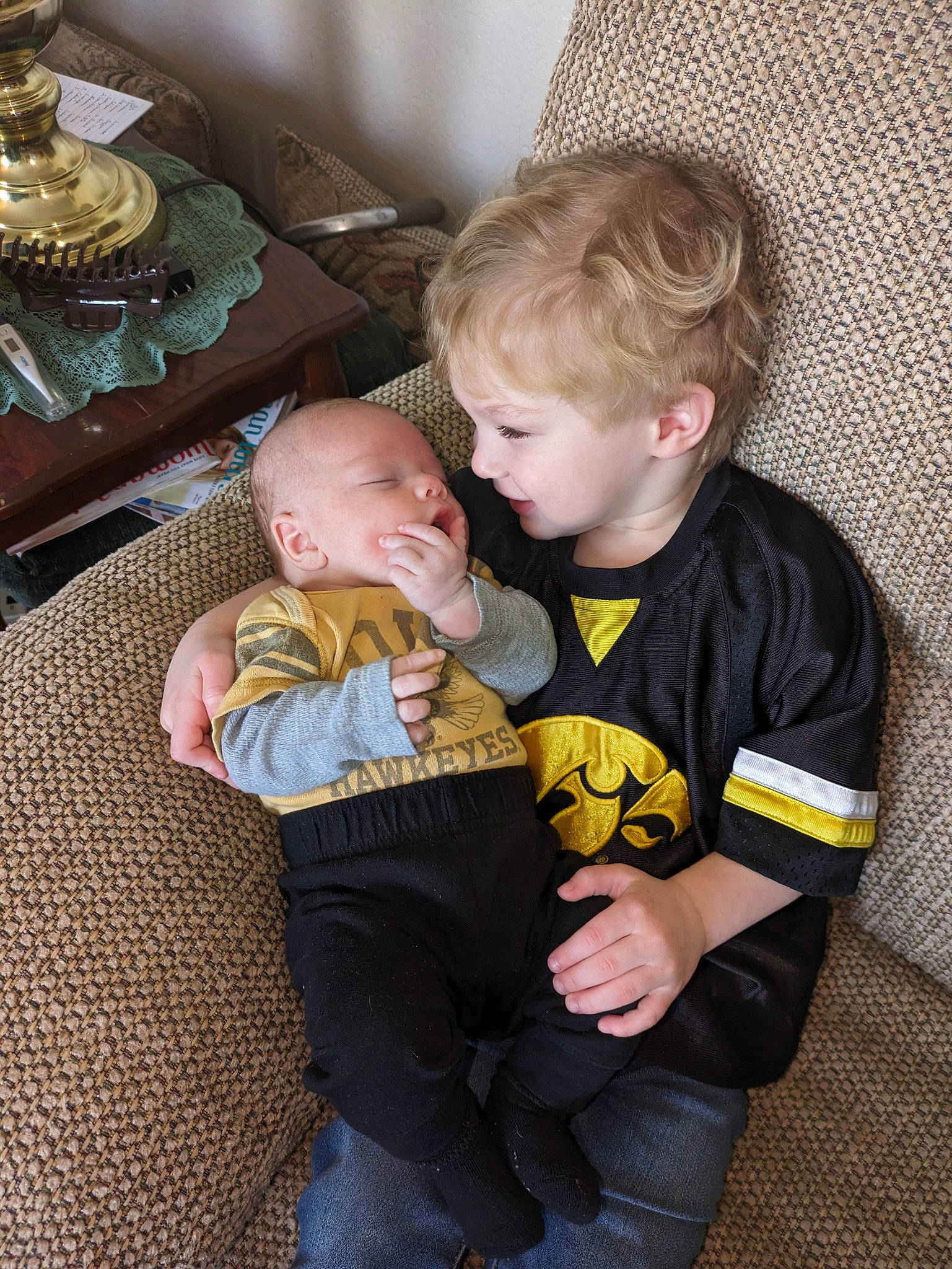 Ragnar And Levi is registered to the contest to win money with this photo: baby, baby_toddler_clothing, chair, cheek, child, comfort, couch, event, eye, facial_expression, fun, hairstyle, hat, head, lap, leg, organ, person, sitting, skin