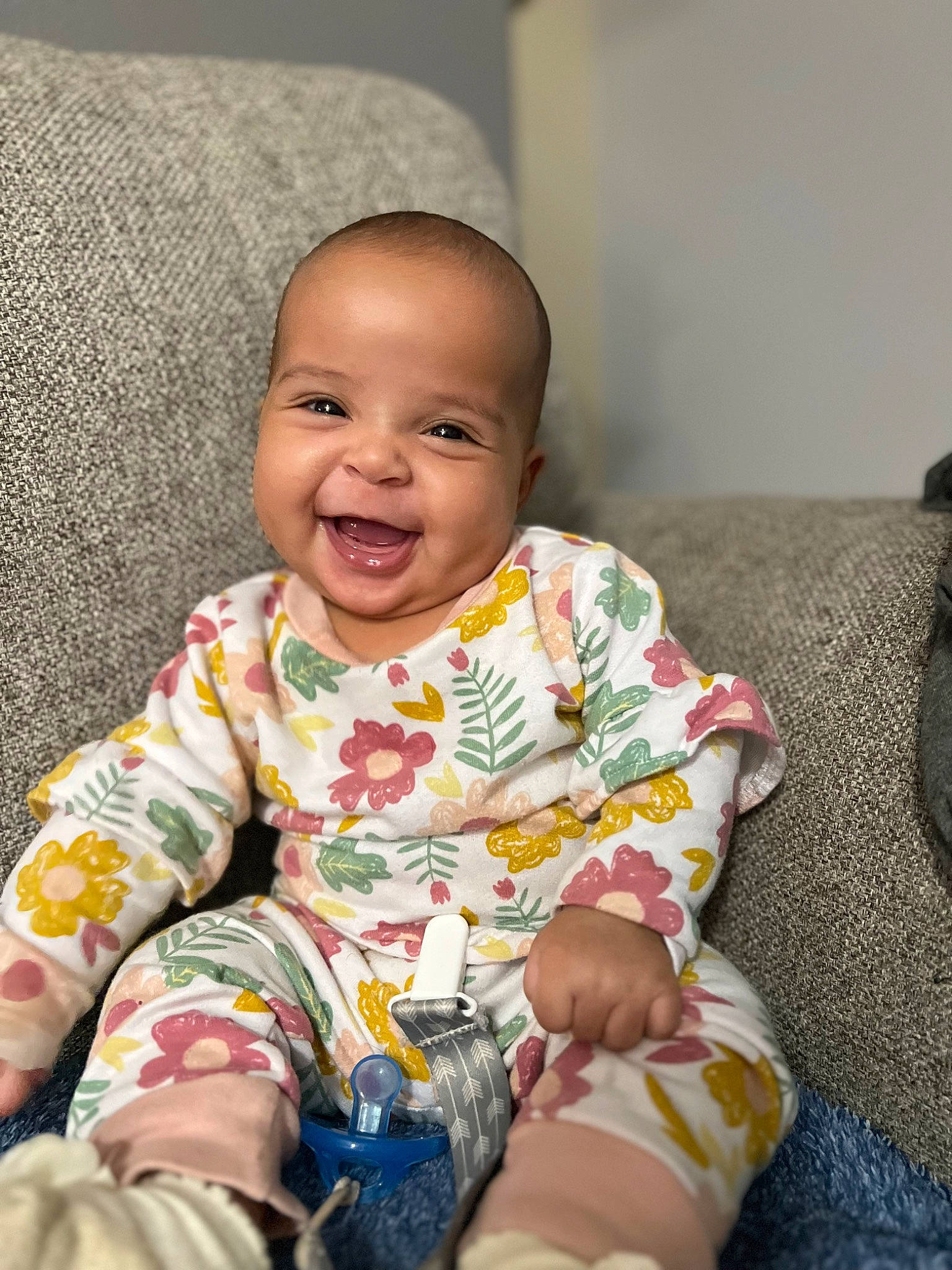 Elizabeth is registered to the contest to win money with this photo: baby, baby_laughing, baby_toddler_clothing, cheek, child, comfort, eye, flooring, happy, linens, nightwear, pattern, person, product, sitting, skin, sleeve, smile, sock, t_shirt