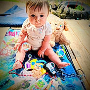 Kinsley joined the competition — help win amazing prizes! baby, child, infant, sitting, portrait, face, eyes, outdoor, playmat, toys, stuffed_animal, puppy, bubbles, beads, rattle, toy_phone, colorful, playtime, garden, smiling