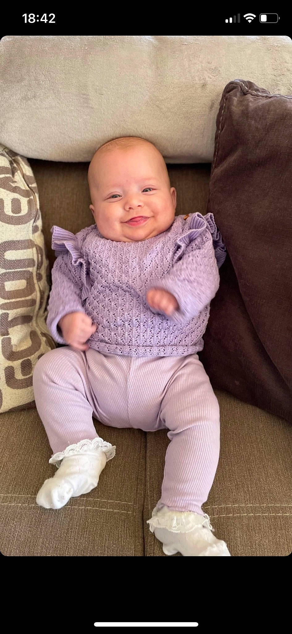 Rose participe au concours pour gagner de l'argent avec cette photo : baby, baby_toddler_clothing, cheek, child, comfort, face, finger, foot, human_leg, joy, knee, leg, neck, pattern, person, purple, sitting, skin, sleeve, smile