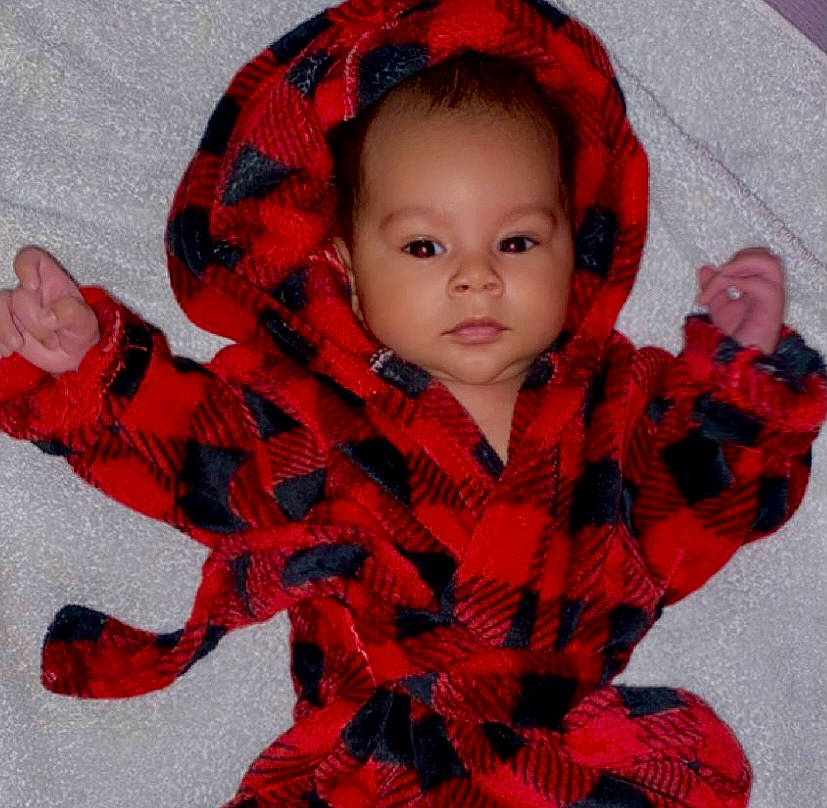 Josiah is registered to the contest to win money with this photo: baby_toddler_clothing, cheek, child, eye, fashion_accessory, head, human_body, knit_cap, lip, neck, pattern, person, plaid, red, scarf, shawl, sleeve, textile, toddler, wool