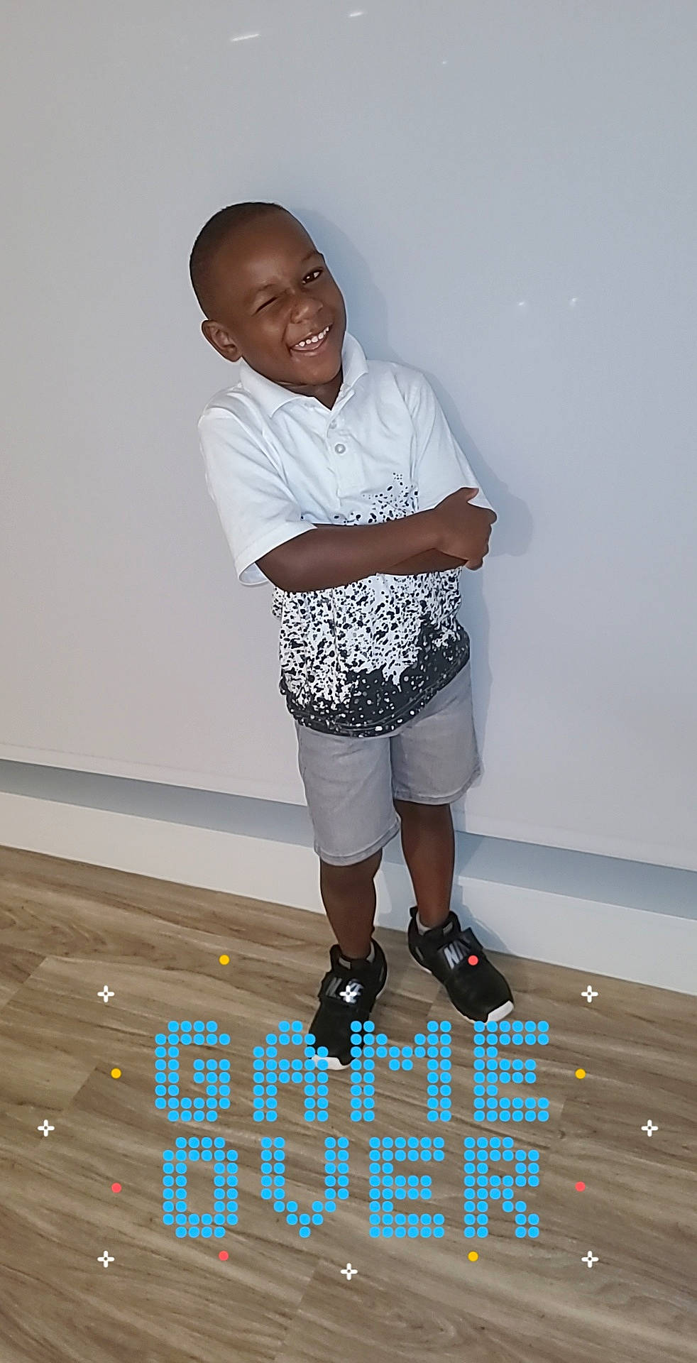 Hassan is registered to the contest to win money with this photo: active_shorts, athletic_shoe, bermuda_shorts, buzz_cut, calf, cool, elbow, human_leg, joint, joy, knee, laugh, outdoor_shoe, person, shirt, shorts, sleeve, sneakers, sock, standing