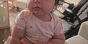 Jackeline joined the competition — help win amazing prizes! baby, bow, child, couch, curly_hair, cute, earrings, face, furniture, hand, home, indoor, infant, living_room, orange_pants, person, pink_shirt, portrait, sitting, soft_light