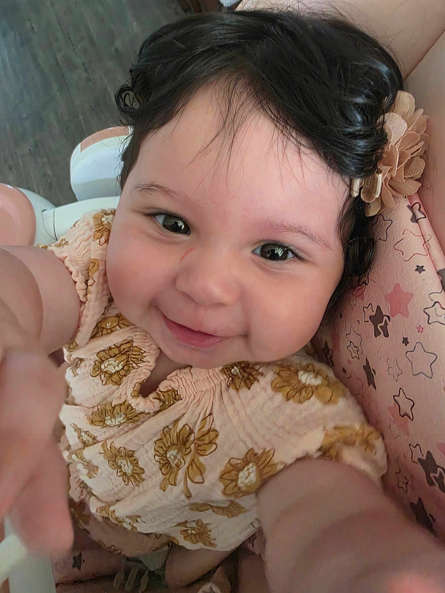 Jackeline joined the competition — help win amazing prizes! baby, child, smiling, face, hair, flower, clothing, pattern, sunflower, seat, cushion, star_pattern, happy, portrait, infant, cute, skin, hand, indoor, closeup
