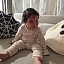 Jackeline joined the competition — help win amazing prizes! baby, child, couch, cozy, curtains, cute, decor, fabric, foot, ghost_pillow, hair_clip, hand, indoors, living_room, pajamas, person, pillow, sitting, smiling, spider_web_pillow