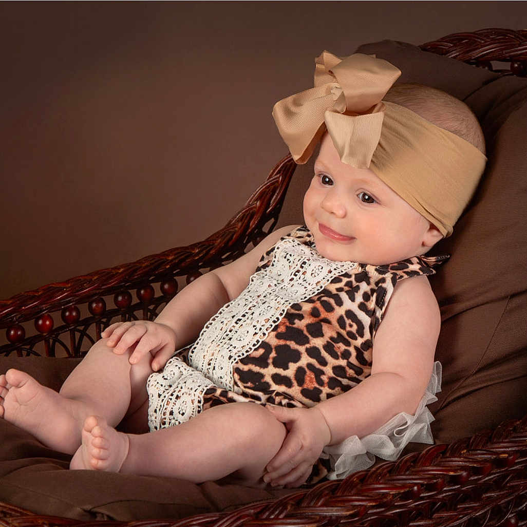 Amélie is registered to the contest to win money with this photo: baby, bed, bodypart, bonnet, cap, clothing, couch, cushion, dress, face, finger, furniture, hand, hat, head, homedecor, person, photography, portrait, sitting