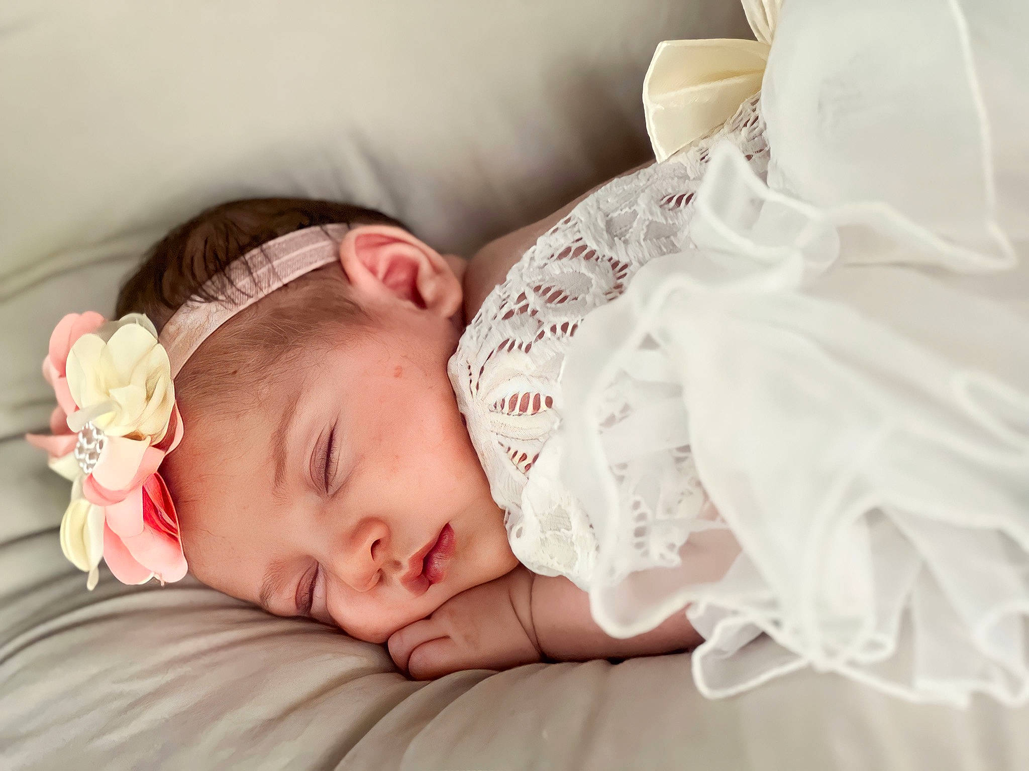Lydia is registered to the contest to win money with this photo: arm, baby, baby_sleeping, baby_toddler_clothing, bedtime, cheek, child, comfort, ear, eyebrow, eyelash, fashion_accessory, hair_accessory, hand, happy, headwear, linens, lip, person, skin