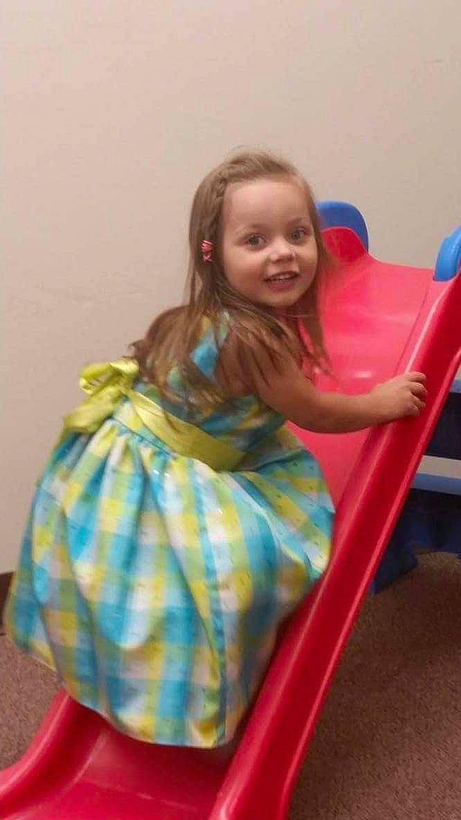 Jayden is registered to the contest to win money with this photo: baby_toddler_clothing, blond, child, comfort, dress, electric_blue, fun, happy, human_leg, joy, leisure, magenta, pattern, person, plaid, play, recreation, room, sitting, smile