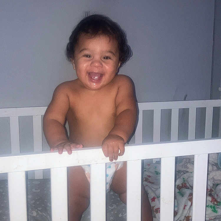 Kashton joined the competition — help win amazing prizes! baby, bedding, bedroom, child, crib, crib_rail, cute, diaper, family_photos, happy, indoors, infant, laughing, moon_pattern, nursery, portrait, smiling, standing, wall_art, wooden_furniture