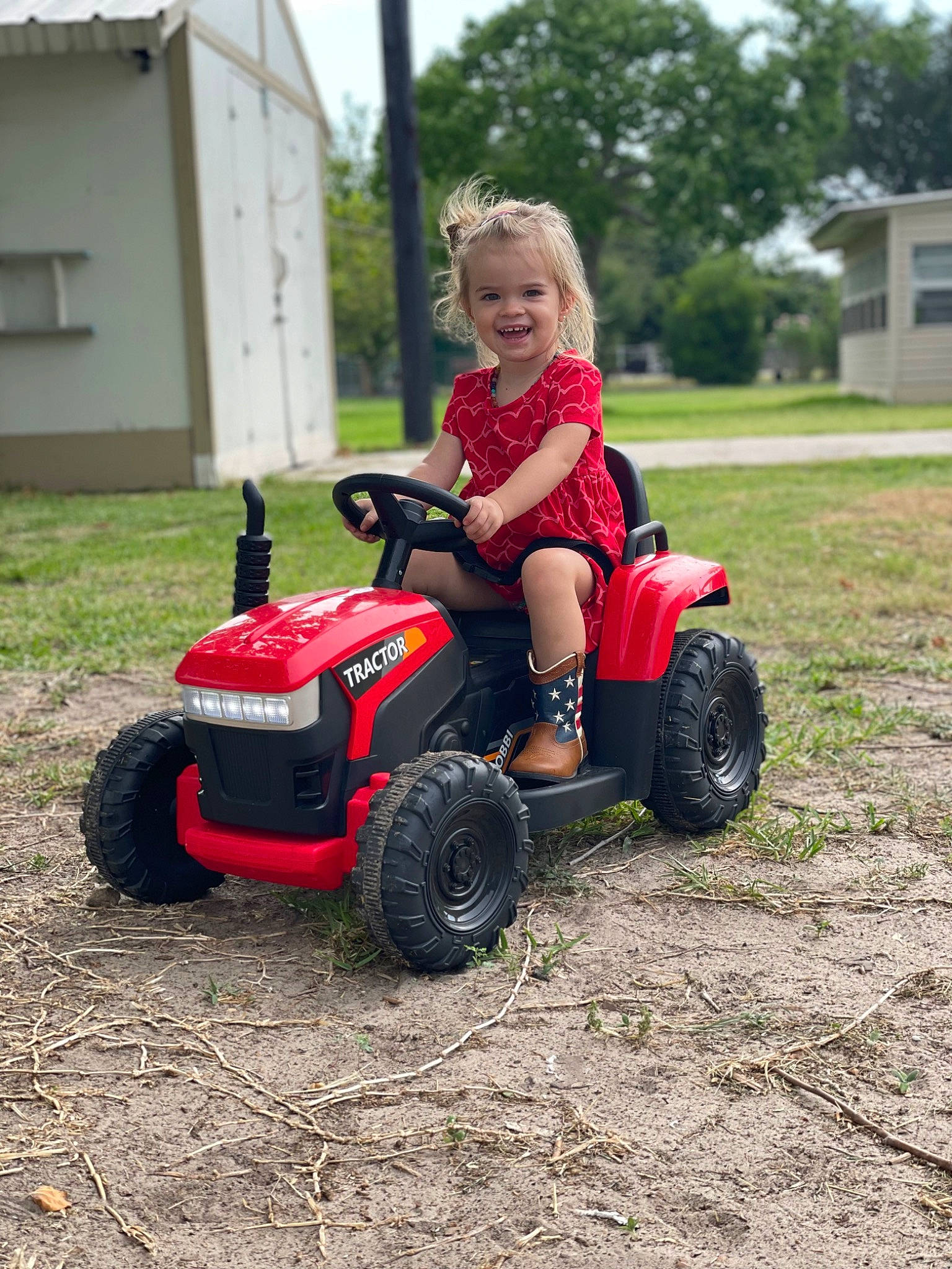 Alexia joined the competition — help win amazing prizes! automotive_design, automotive_exterior, automotive_tire, automotive_wheel_system, bumper, fender, grass, joy, lawn, motor_vehicle, person, riding_toy, rim, sky, smile, synthetic_rubber, tire, toddler, tread, tree