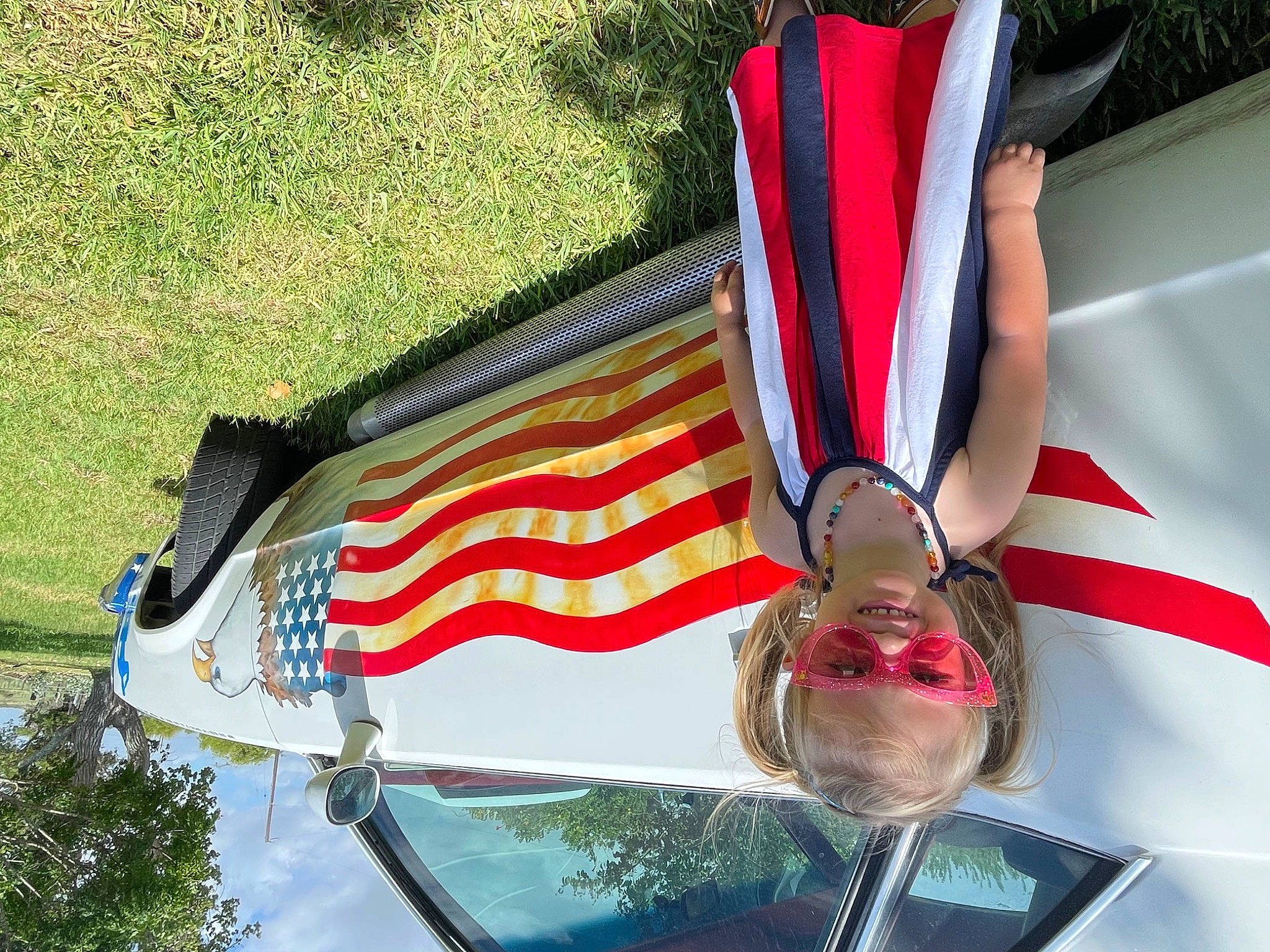 Alexia joined the competition — help win amazing prizes! automotive_design, automotive_exterior, automotive_lighting, automotive_wheel_system, car, carmine, classic, dress, event, eyewear, flag, flag_day_usa, flag_of_the_united_states, hood, joy, motor_vehicle, person, plant, tie, tree