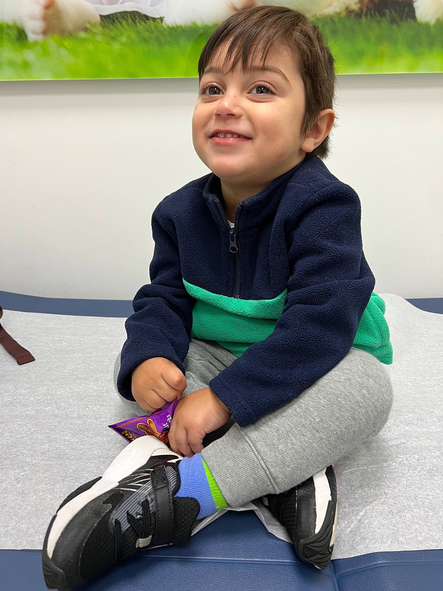 Mason is registered to the contest to win money with this photo: boot, child, fun, grass, happy, human_leg, joy, knee, leisure, mammal, person, plant, play, recreation, sitting, sleeve, smile, sneakers, sock, sportswear