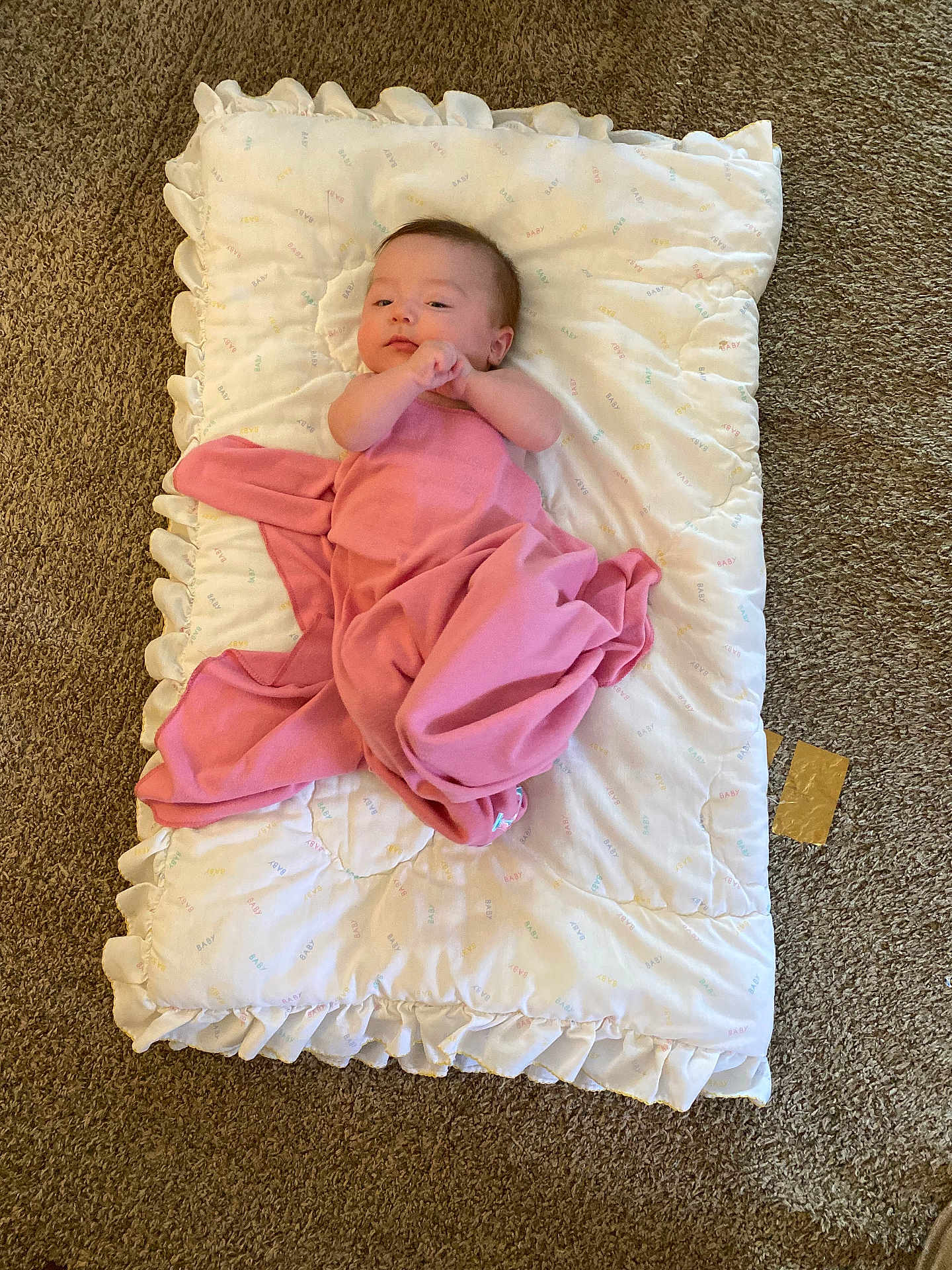 Adelaide is registered to the contest to win money with this photo: baby, infant, blanket, pillow, carpet, pink_blanket, swaddle, lying_down, indoor, portrait, cute, newborn, person, face, head, cozy, ruffles, fabric, floor, home