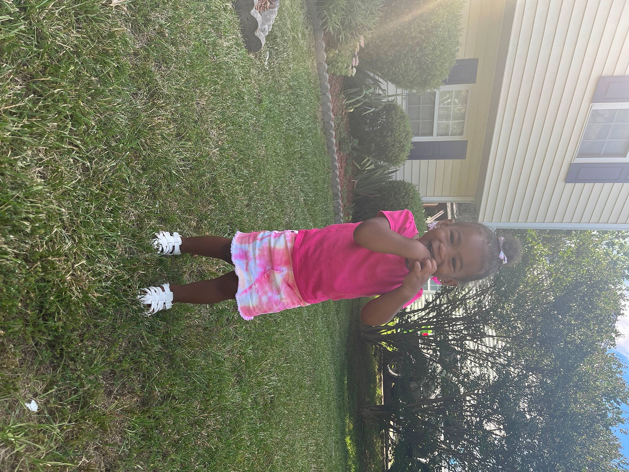 Kalani joined the competition — help win amazing prizes! fun, garden, grass, happy, house, leisure, magenta, people_in_nature, person, plant, shadow, shrub, sky, toddler, tree, window, yard