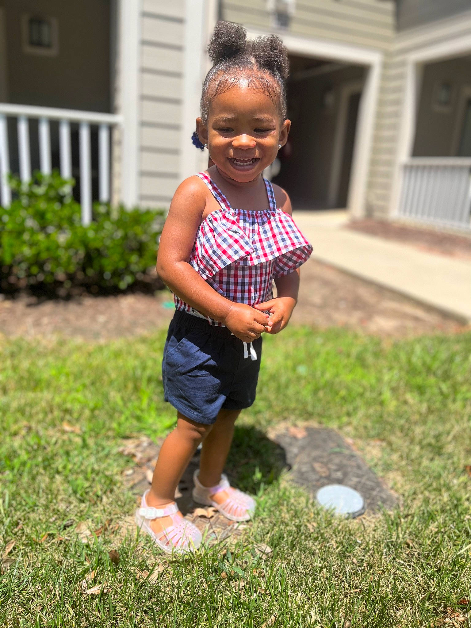 Kalani is registered to the contest to win money with this photo: ball, child, eye, face, fun, grass, happy, head, house, human_leg, joy, lawn, leisure, people_in_nature, person, plant, recreation, shorts, smile, summer