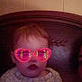 Summer joined the competition — help win amazing prizes! baby, casual_clothing, child, dim_lighting, expressionless, eyewear, face, filter, glasses, headboard, heart_shaped, indoor, pink, portrait, shirt, sitting, text_on_clothing, toddler, wood, young_child