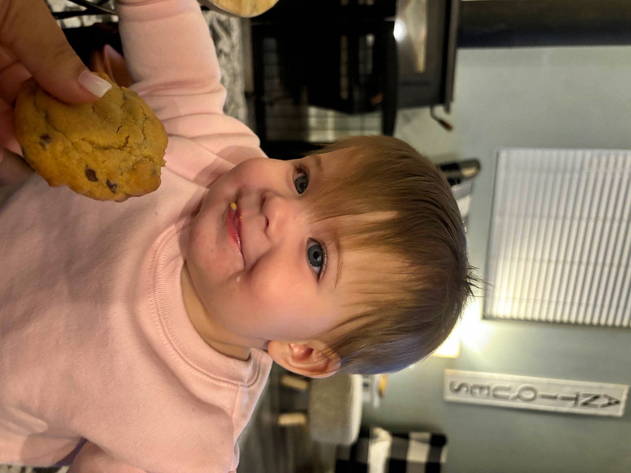 Oakley is registered to the contest to win money with this photo: baby, cheek, child, chin, ear, eating, finger, food, fun, happy, hat, joy, mouth, nose, person, room, sitting, skin, smile, thumb