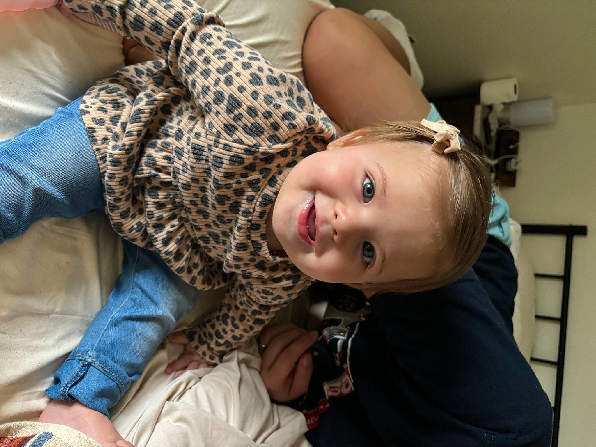Oakley is registered to the contest to win money with this photo: baby, cheek, child, comfort, elbow, eyelash, flooring, fun, fur, gesture, happy, joy, pattern, person, room, sitting, skin, smile, toddler