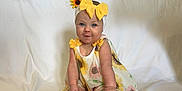 Teagan joined the competition — help win amazing prizes! baby, child, cake, cake_smash, yellow_bow, sunflower, headband, dress, smiling, blue_eyes, white_backdrop, decorative_flowers, wooden_platter, messy, celebration, sitting, cute, infant, playful, portrait