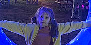 Arabella joined the competition — help win amazing prizes! child, girl, pigtails, yellow_jacket, jeans, blue_light, glowing_circle, night, park, picnic_table, people, decorations, animal_lights, outdoor, trees, playful, fun, casual, evening, event