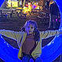 animal_lights, blue_light, casual, child, decorations, evening, event, fun, girl, glowing_circle, jeans, night, outdoor, park, people, picnic_table, pigtails, playful, trees, yellow_jacket