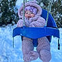 Natalie is registered to the contest to win money with this photo: baby, child, swing, winter, snow, outdoor, cold, blue_swing, pink_snowsuit, hat, smiling, face, happy, frost, trees, fuzzy_clothing, playground, seasonal, cute, infant