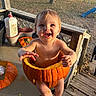 Noah joined the competition — help win amazing prizes! baby, pumpkin, smiling, outdoor, porch, table, fall, autumn, child, face, happy, playground, wood, fence, grass, leaf, seasonal, nature, daylight, cute