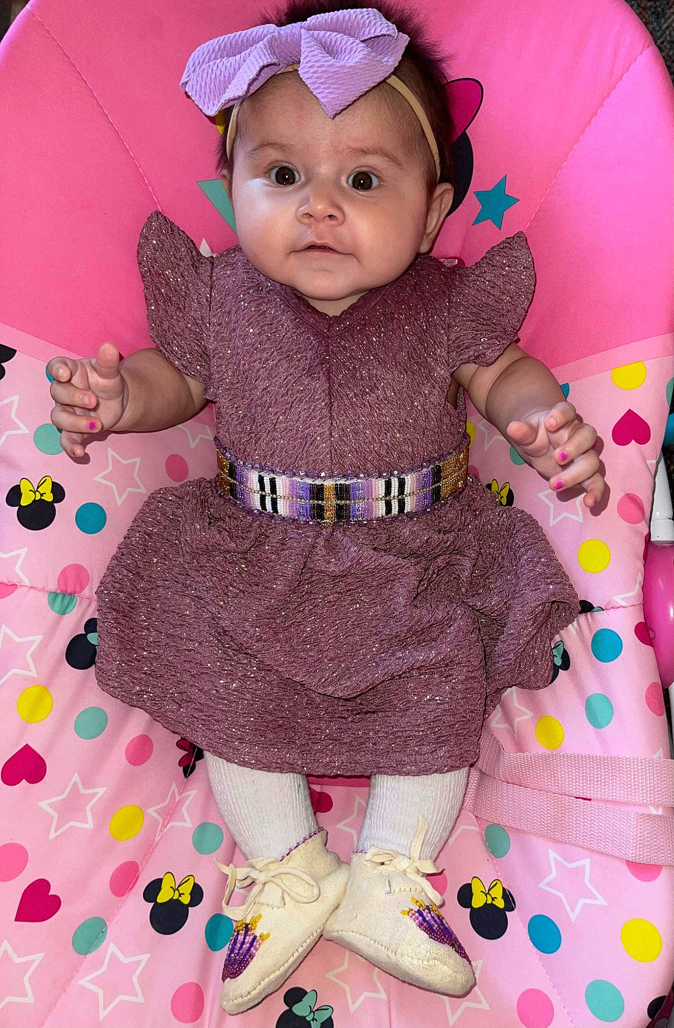Taisley is registered to the contest to win money with this photo: baby, baby_products, baby_toddler_clothing, cheek, child, facial_expression, fashion_accessory, hand, happy, headwear, magenta, pattern, person, pink, purple, sitting, skin, sleeve, textile, toddler