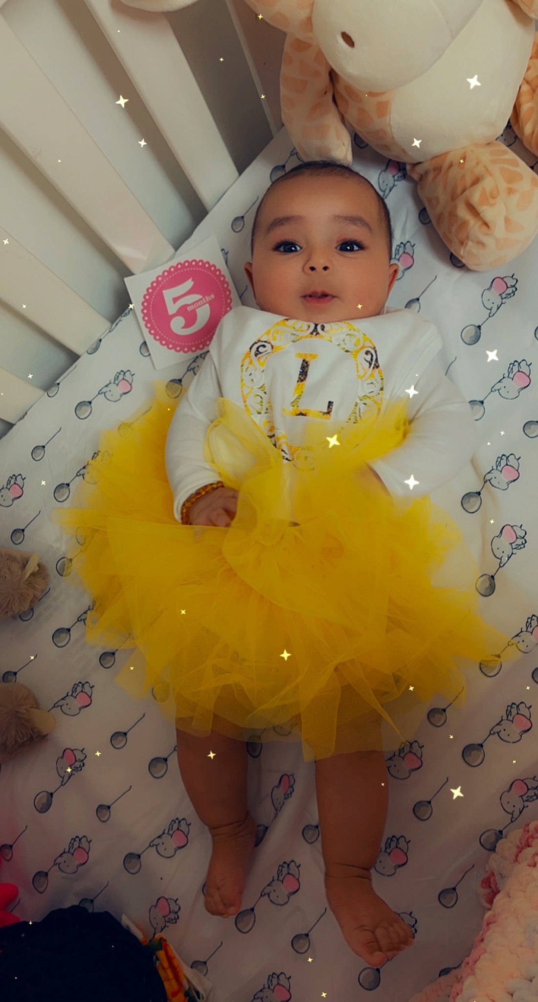 Lucille is registered to the contest to win money with this photo: baby, baby_products, baby_toddler_clothing, child, day_dress, dress, fashion_design, fun, happy, head, iris, one_piece_garment, pattern, person, pink, skin, sleeve, smile, textile, toddler