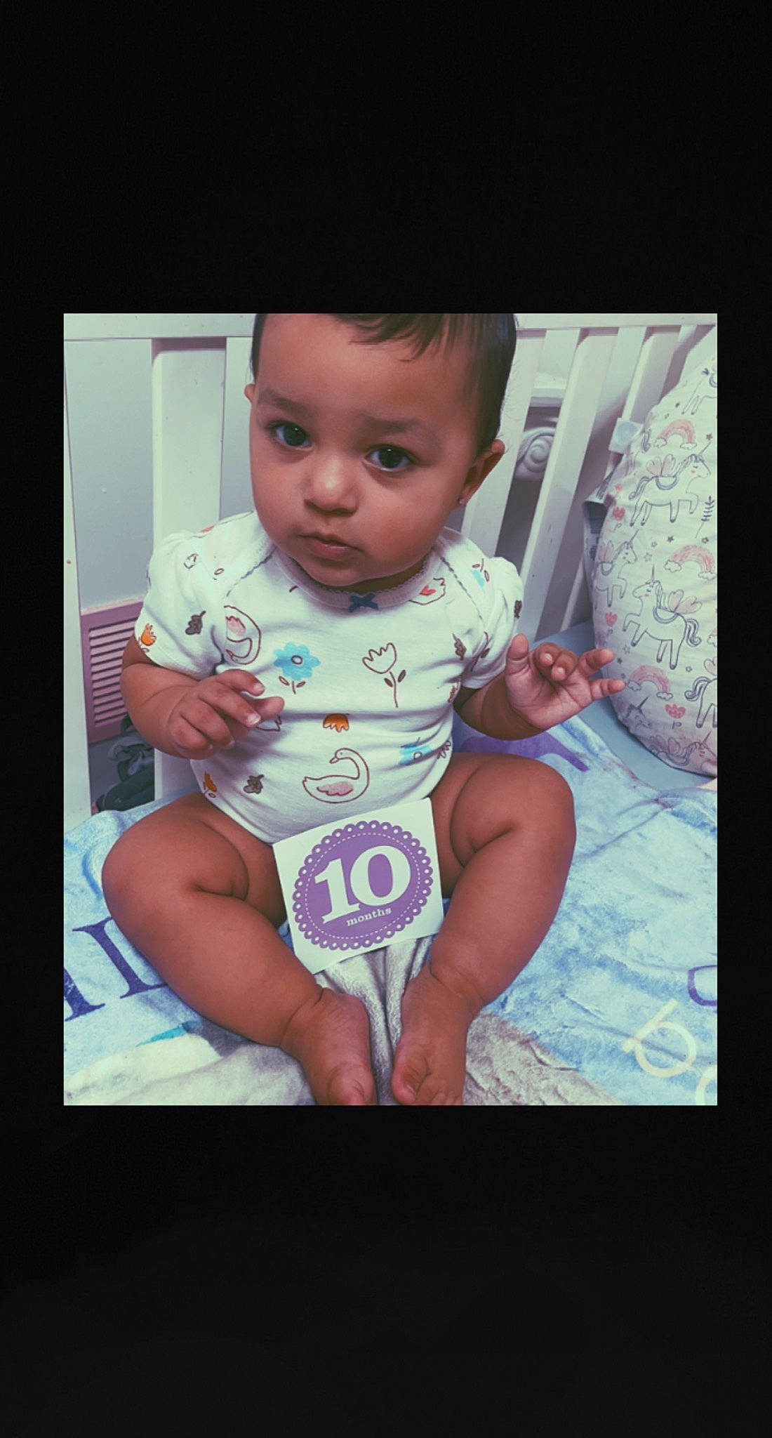 Lucille is registered to the contest to win money with this photo: baby, baby_toddler_clothing, cheek, cool, electric_blue, finger, flash_photography, fun, happy, human_leg, magenta, nail, pattern, person, pink, purple, sitting, sleeve, t_shirt, thumb