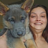 Xena is registered to the contest to win money with this photo: woman, puppy, dog, german_shepherd, pet, smiling, portrait, indoor, human, animal, face, happy, holding, cute, furry, friendship, closeup, ceiling_fan, tattoo, casual