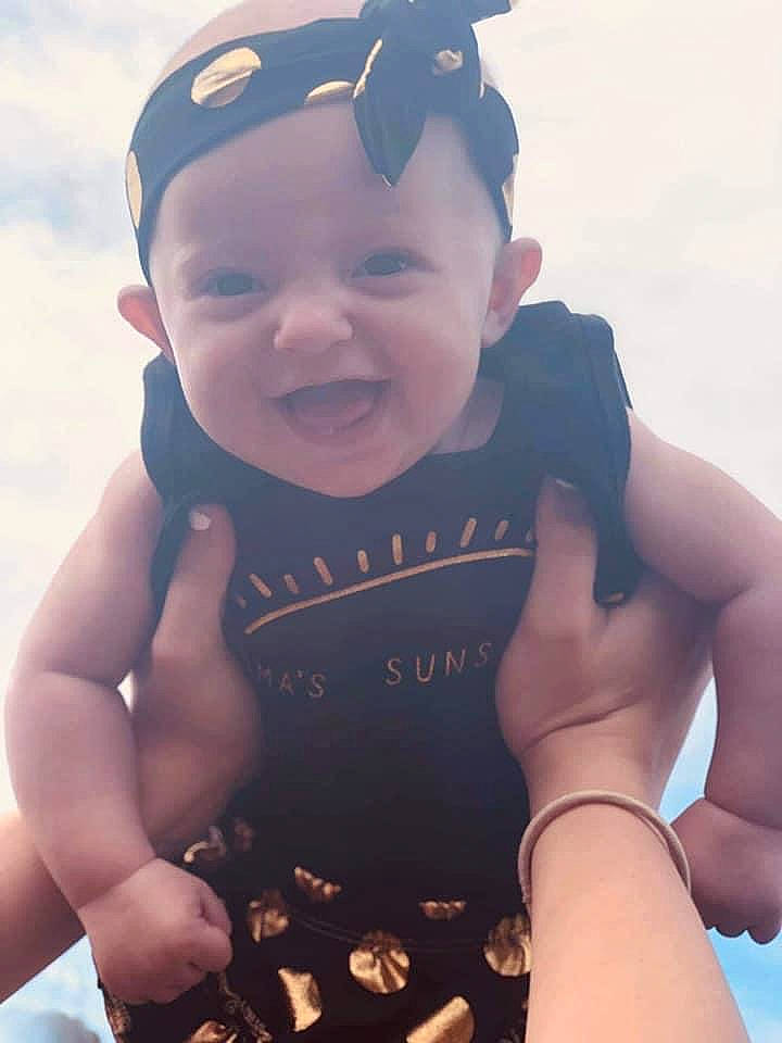 Koda joined the competition — help win amazing prizes! arm, baby, child, cool, finger, gesture, hand, happy, headwear, muscle, person, personal_protective_equipment, photography, smile, summer, toddler, vacation, wetsuit