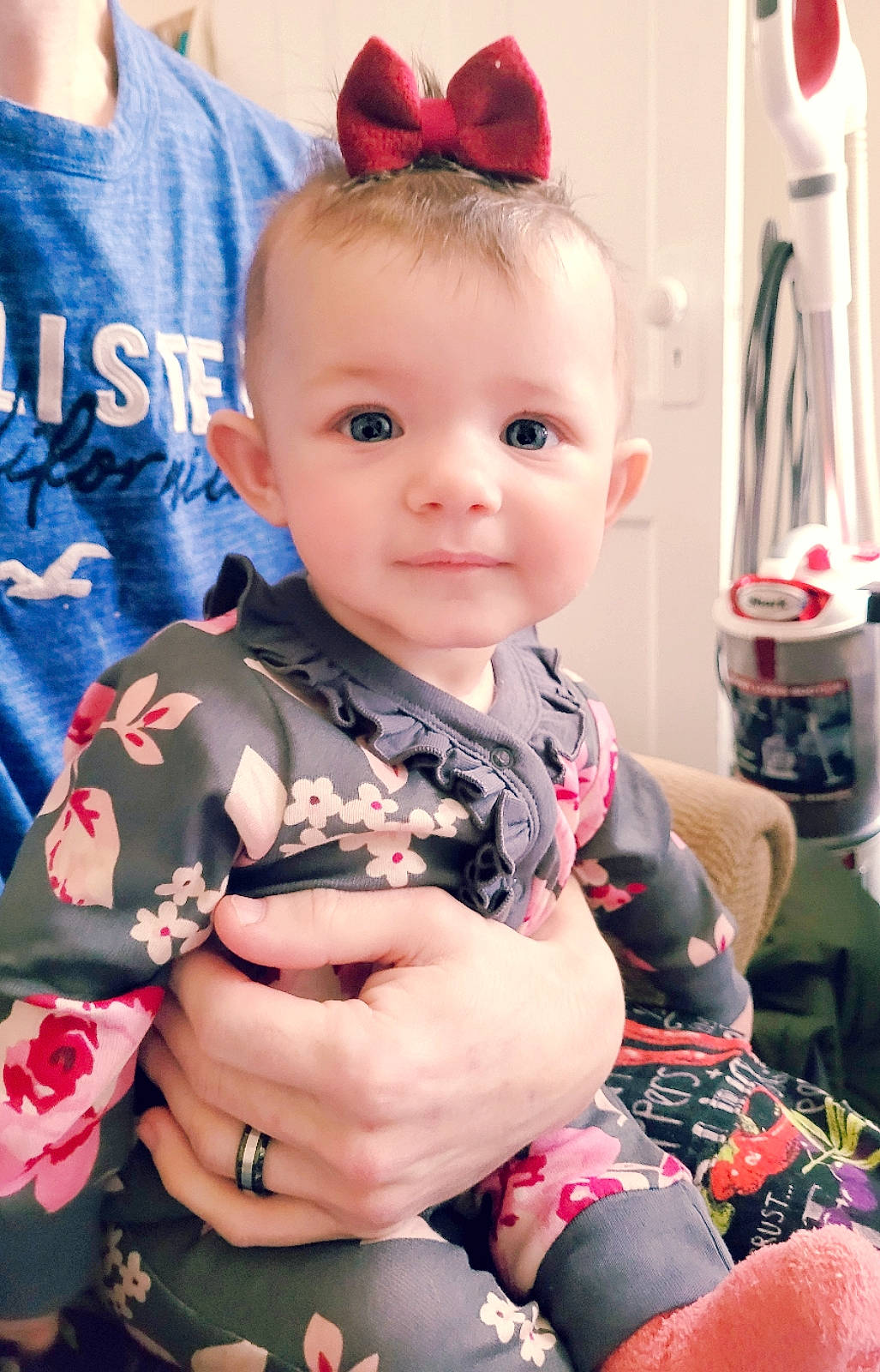 Kayli is registered to the contest to win money with this photo: baby, baby_products, baby_toddler_clothing, cheek, child, dress, electric_blue, event, eye, eyelash, fashion_accessory, hand, happy, pattern, person, pink, red, sitting, skin, sleeve