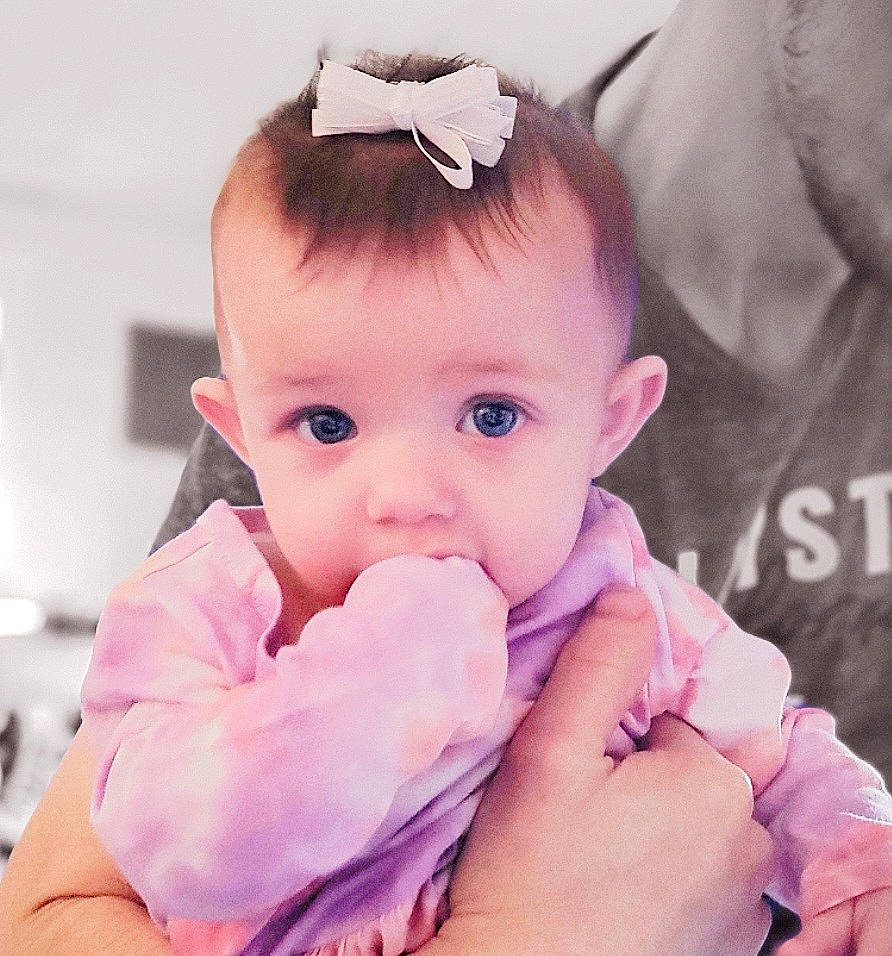 Kayli is registered to the contest to win money with this photo: baby, baby_toddler_clothing, cheek, chin, eye, eyebrow, eyelash, face, finger, gesture, hand, happy, head, iris, lip, neck, nose, person, skin, sleeve