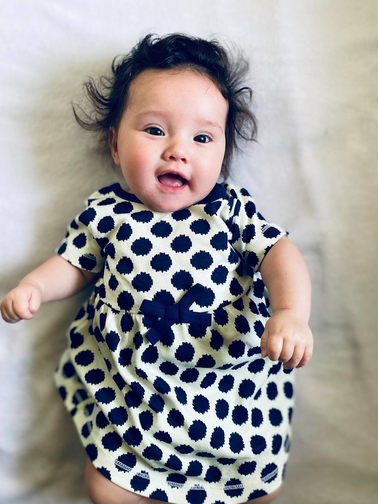 Remmi is registered to the contest to win money with this photo: arm, baby, baby_toddler_clothing, child, clothing, collar, day_dress, dress, electric_blue, face, hairstyle, happy, outerwear, pattern, person, skin, sleeve, smile, standing, t_shirt