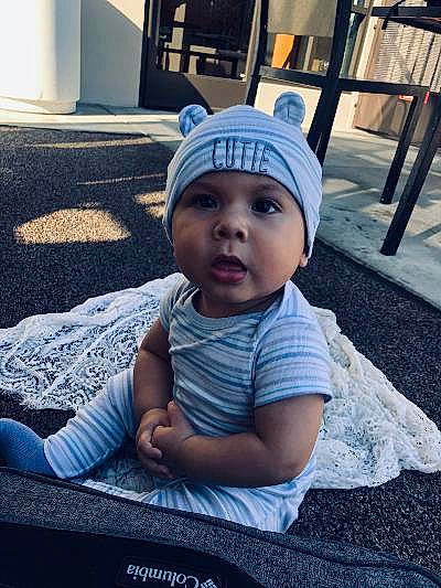 Kevin joined the competition — help win amazing prizes! baby, beanie, cap, child, cool, head, headgear, headwear, knit_cap, people, person, sitting, smile, toddler, vacation