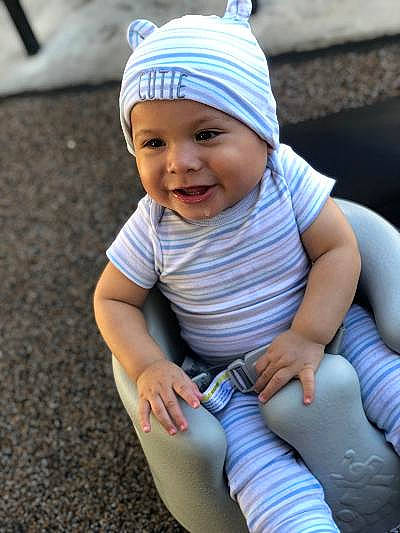 Kevin joined the competition — help win amazing prizes! baby, baby_products, cheek, child, headgear, headwear, joy, person, sitting, skin, smile, toddler