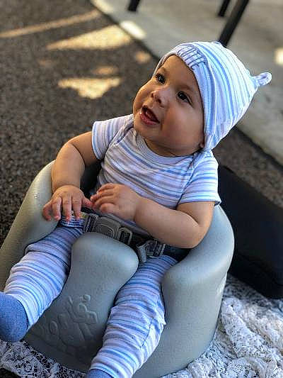 Kevin is registered to the contest to win money with this photo: baby, beanie, cap, child, headgear, headwear, person, sitting, smile, toddler